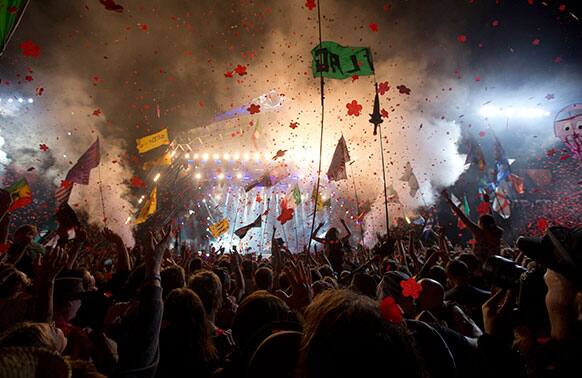 The crowd watches British band the Rolling Stones perform on the Pyramid main stage at Glastonbury, England.