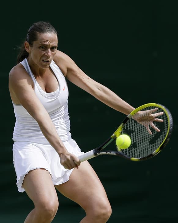 Roberta Vinci of Italy returns to Dominika Cibulkova of Slovakia in a Women`s singles match at the All England Lawn Tennis Championships in Wimbledon, London.