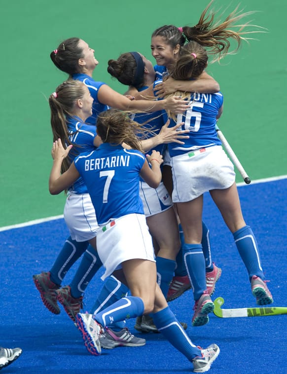 Italy players celebrate after scoring the winning penalty shot during their game against South Africa during the Investec World League Semi Finals, in Chiswick, London.