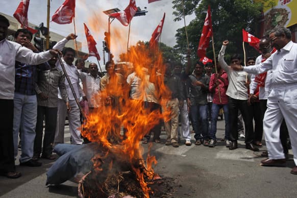 Activists of Communist Party of India (CPI) burn an effigy representing India`s ruling United Progressive Allaince (UPA) government against the hike in fuel price in Hyderabad.