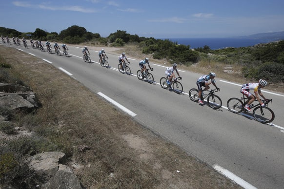 The pack rides along the coast line of the Mediterranean Sea during the first stage of the 100th edition of the Tour de France cycling race over 213 kilometers (133 miles) with start in Porto Vecchio and finish in Bastia, Corsica island, France.