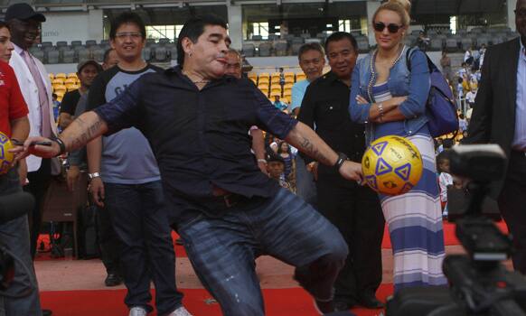 Argentina soccer legend Diego Armando Maradona kicks the ball during a coaching clinic for Indonesian youths at Gelora Bung stadium in Jakarta.