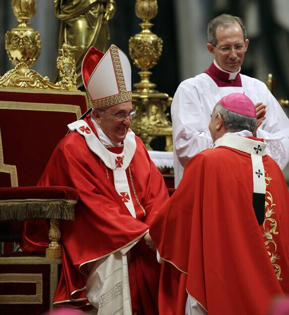 Monsignor Mario Aurelio Poli, Archbishop of Buenos Aires, Argentina, is greeted by Pope Francis after receiving the Pallium, a woolen shawl symbolizing his bond to the pope, during a mass in St. Peter`s Basilica, at the Vatican.