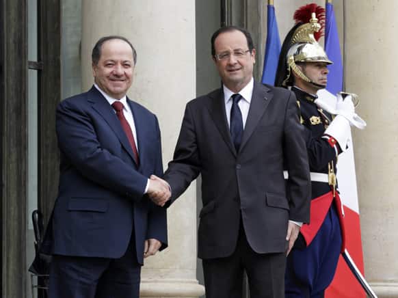 French President Francois Hollande, greets the President of the Iraqi Kurdistan Region Massoud Barzani, prior to their meeting at the Elysee Palace in Paris.