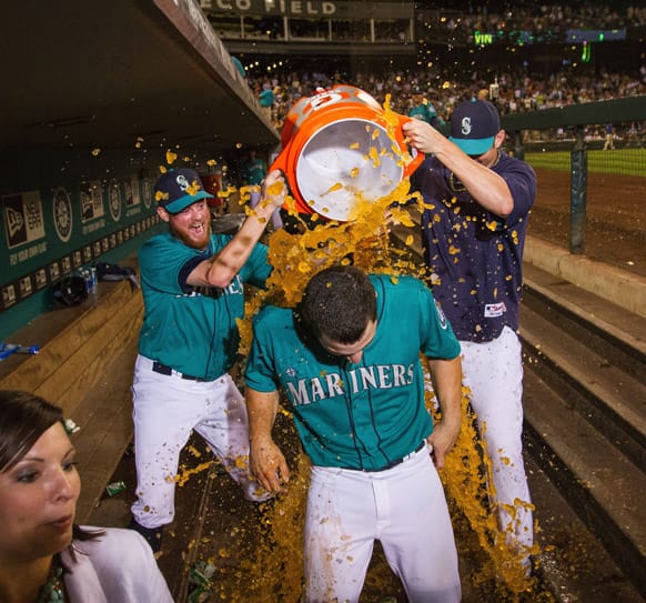Mike Zunino is doused with a Gatorade bath after scoring the winning run in the tenth inning with a walk off single in a baseball game against the Chicago Cubs.