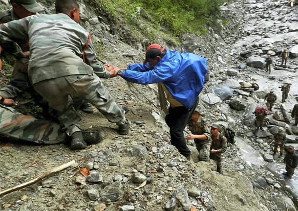 Army soldiers help a man up a slope at Pindari Glacier, in the northern Indian state of Uttarakhand.