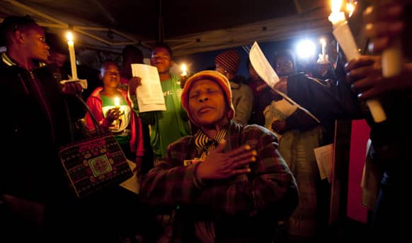 A group of wellwishers sing and pray for the health of Nelson Mandela at night outside the Mediclinic Heart Hospital where former South African President Nelson Mandela is being treated in Pretoria, South Africa.