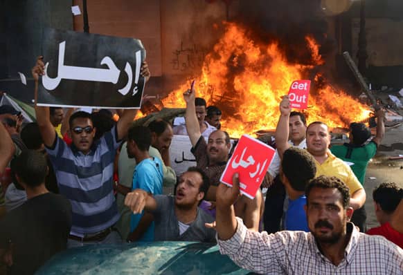 Opponents of Egypt`s Islamist President Mohammed Morsi hold Arabic signs reading