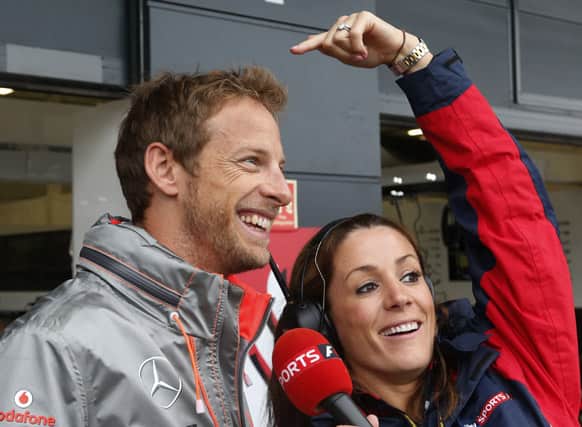 McLaren Mercedes driver Jenson Button of Britain jokes with a member of the media while he is being interviewed, during the first practice at the Silverstone circuit, England.
