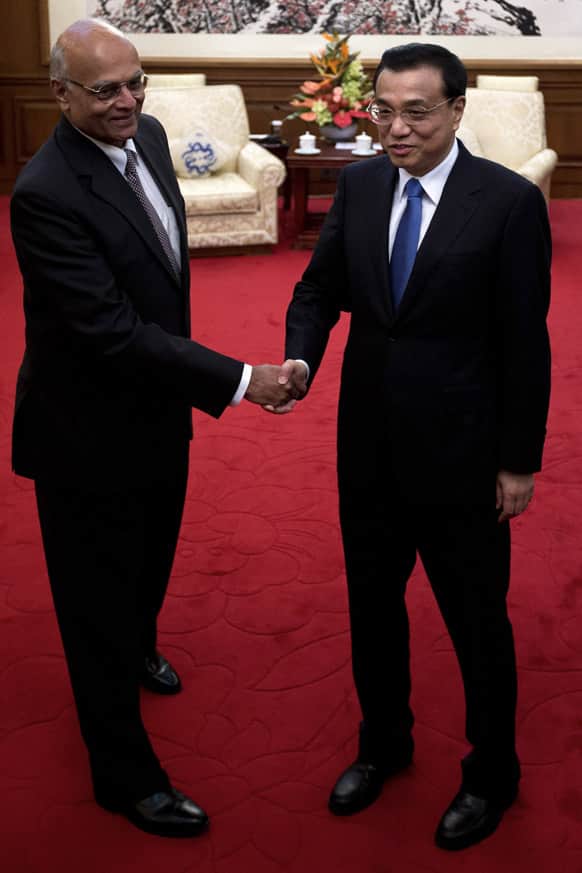 Chinese Premier Li Keqiang, right, shakes hands with Indian National Security Adviser Shivshankar Menon at Diaoyutai State Guesthouse in Beijing.