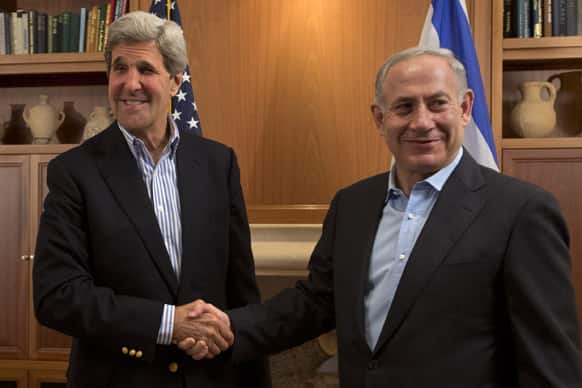 US Secretary of State John Kerry, left, shakes hands with Israeli Prime Minister Benjamin Netanyahu during their meeting in Jerusalem.