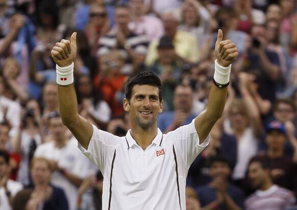 Novak Djokovic of Serbia reacts after defeating Bobby Reynolds of the United States in their Men`s second round singles match at the All England Lawn Tennis Championships in Wimbledon.