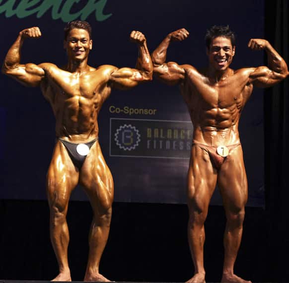 Bodybuilders compete during their bodybuilding contest organized by Myanmar Bodybuilder Federation at Myanmar Convention Center (MCC) Thursday, June 27, 2013, in Yangon.