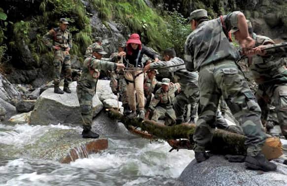 Indian army soldiers rescue a woman at Pindari Glacier, in the northern Indian state of Uttarakhand.