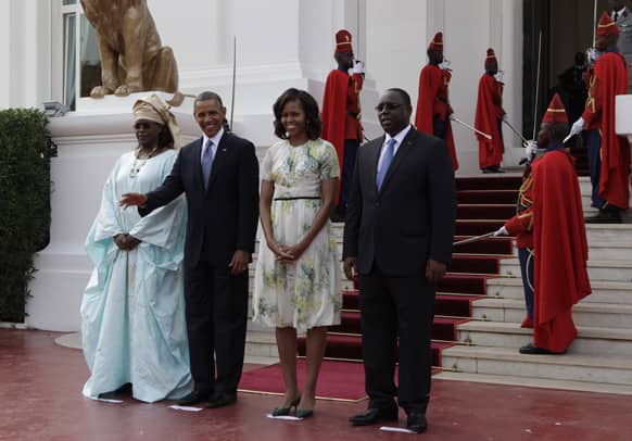 US President Barack Obama waves as he poses for a picture alongside First Lady Michelle Obama, Senegalese President Macky Sall and Senegalese First Lady Mariame Faye Sall, at the presidential palace in Dakar, Senegal.