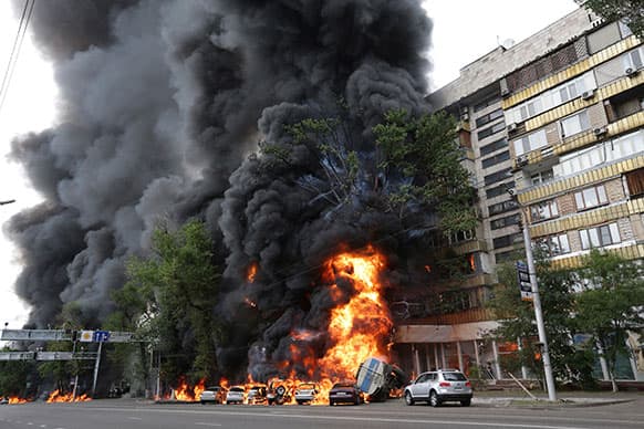 A multi-story building is engulfed by flames after a road accident in downtown Almaty, Kazakhstan. According to witnesses, the fire was a result of a petrol tank lorry that exploded near Rixos hotel at the crossing killing one person and destroying 20 apartments.