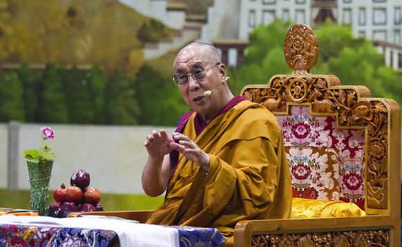 Tibetan spiritual leader the Dalai Lama gestures as he talks to young Tibetans at the Tibetan Children`s Village School in Dharmsala.