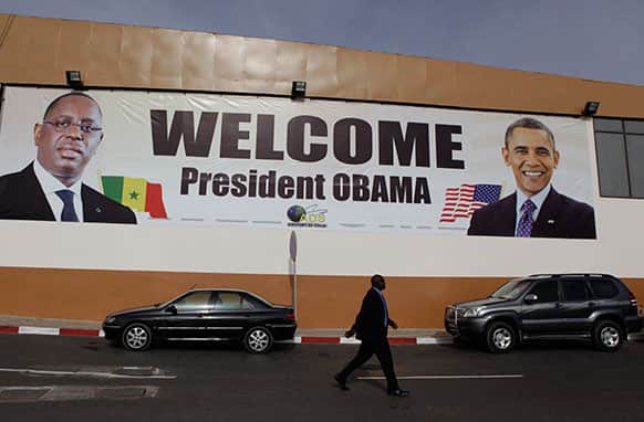 A banner showing US President Barack Obama and Senegalese counterpart Macky Sall hangs at the airport in Dakar, Senegal.