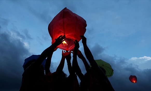 Indian Sadhus or Hindu holy men release a sky lantern to signify world peace at the end of the annual Ambubasi festival in Gauhati.