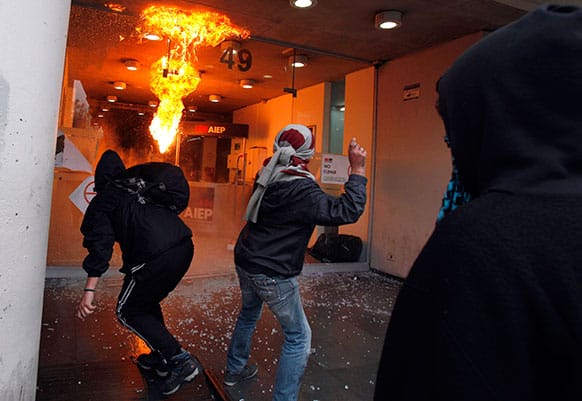 Demonstrators throw Molotov cocktails and rocks at an institute of technology during a nationwide demonstration in Santiago, Chile.