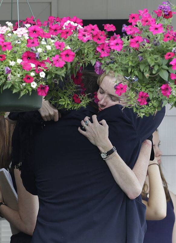 People embrace outside of Robert Spearing Funeral Home during a private viewing for actor James Gandolfini, in Park Ridge, N.J. Gandolfini, who played Tony Soprano in the HBO show