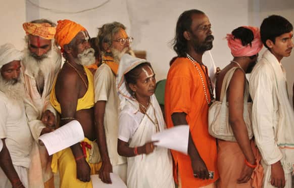 Hindu holy men and a woman stand in a queue for a medical check up before they register for the annual pilgrimage to the Amarnath cave shrine in Jammu.