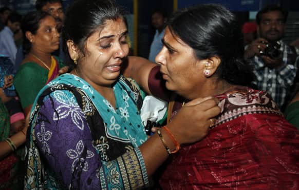 Pilgrim Ramadevi, who was stranded after flash floods and landslides in Uttarakhand state, hugs her relative on her arrival in Hyderabad.