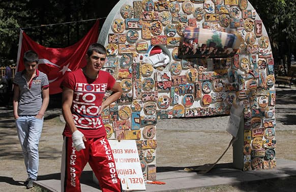 Turkish protesters walk in Kugulu Park in Ankara, Turkey. After weeks of sometimes-violent confrontation with police, Turkish protesters have found a new form of resistance: standing still and silent and forums.