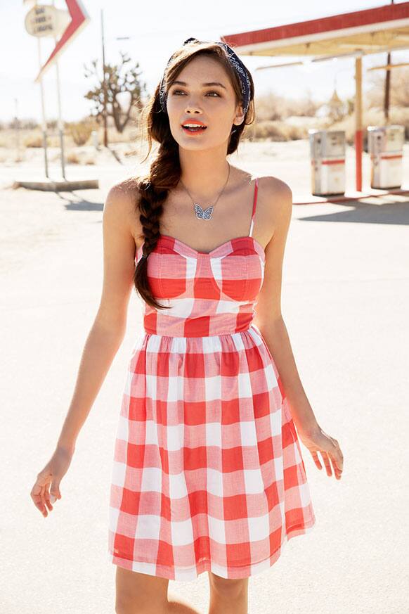 In this product image released by Macy`s, a model wears a red and white checkered sun dress, part of Macy`s American Icons campaign.