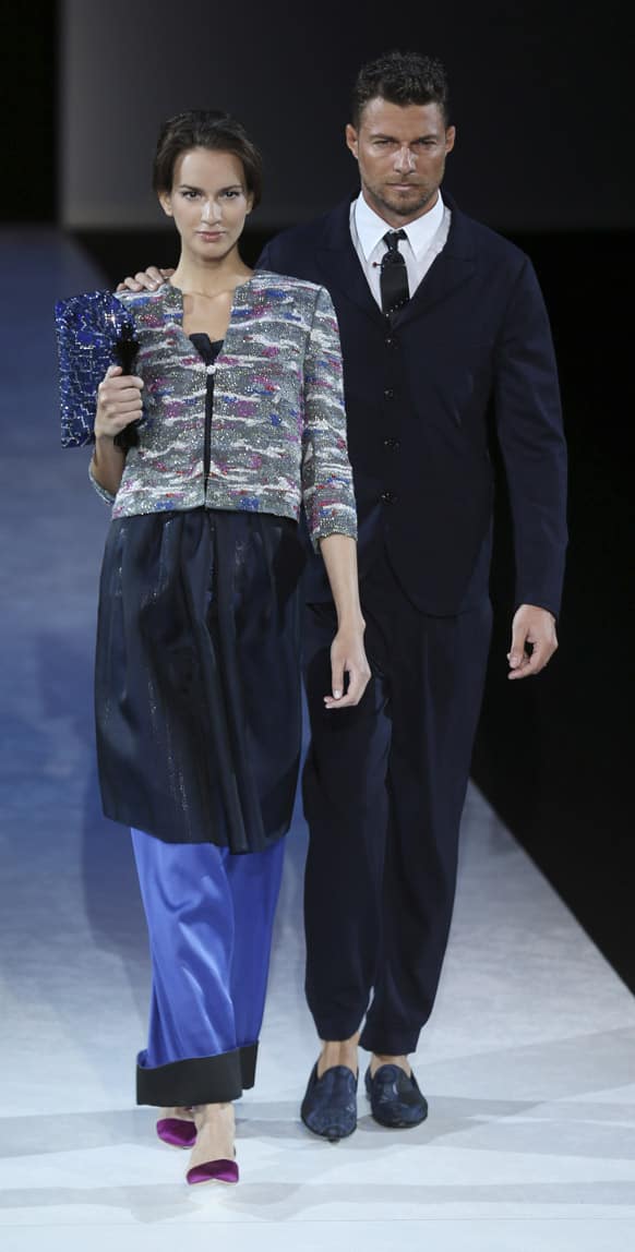Models wear creations for Giorgio Armani men`s Spring-Summer 2014 collection, part of the Milan Fashion Week, unveiled in Milan, Italy.