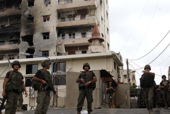 Lebanese army soldiers stand guard near the Bilal bin Rabbah mosque where Sunni cleric Sheik Ahmad al-Assir preaches, in the southern port city of Sidon, Lebanon.