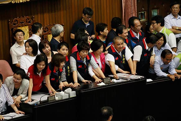 Lawmakers occupy the legislature floor, preventing the session while near-by guest Chinese activist Chen Guangcheng speaks to lawmakers and human rights supporters at an auditorium at the legislature compound in Taipei, Taiwan.