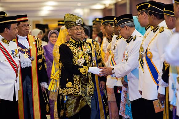 Malaysian King Sultan Abdul Halim Mu`adzam Shah, center, shakes hands with members of Parliament during the opening of the 13th parliament session at the Parliament house in Kuala Lumpur, Malaysia.