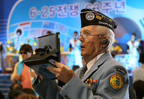 US veteran Leo G. Ruffing from Portsmouth, Va., uses a tablet PC to takes pictures during a ceremony to mark the 63rd anniversary of the outbreak of the Korean War in Seoul, South Korea.