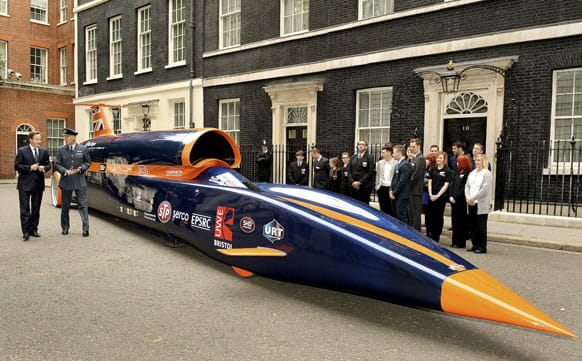 Britain`s Prime Minister David Cameron, left, talks to RAF Pilot Andy Green about the British built Bloodhound Jet Car, that he will drive to try and break the World land speed record of 763 mph (1228 Km per hour), during an event outside 10 Downing Street in London