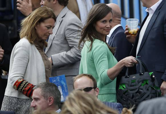 Pippa Middleton, right, and Carole Middleton, sister and mother of Kate,the Duchess of Cambridge, arrive to watch the tennis match between Britain`s Andy Murray and Nicolas Mahut of France, on the centre court at Queen`s Club grass court championships in London.