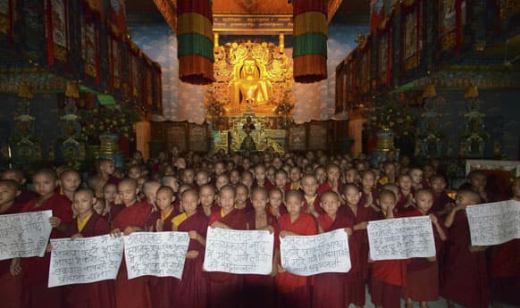 Young Buddhist monks gather at Tergar Monastery to pray for the flood victims of northern Indian state of Uttarakhand, in Bodhgaya.