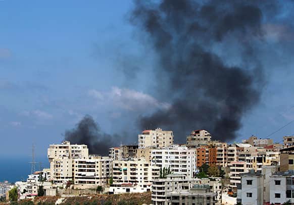 Black smoke rise from a burning house that was attacked during clashes that erupted between followers of a radical Sunni cleric Sheik Ahmad al-Assir and Shiite gunmen in the southern port city of Sidon, Lebanon.