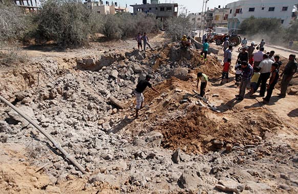 Palestinians inspect the damage following an Israeli air strike in Al-Zawaida in the central Gaza Strip. Israeli aircraft pounded targets in the Gaza Strip early Monday after rockets were fired at Israel from the territory, the military said, unsettling a tenuous cease-fire between Israel and Hamas.