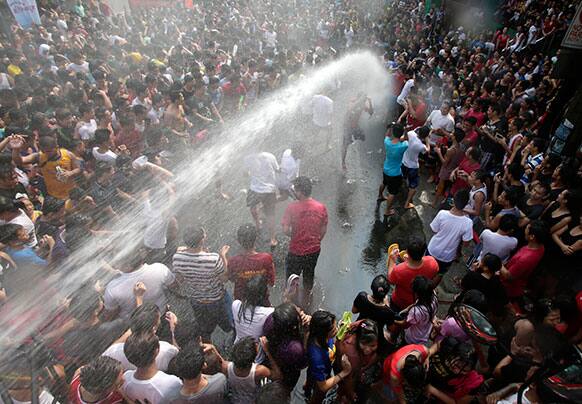 Residents gather along the main street of San Juan, east of Manila, Philippines to celebrate the feast of San Juan township`s patron saint of St. John The Baptist.