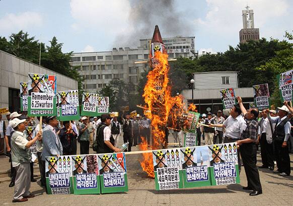 South Korean protesters burn a mock North Korean rocket during a rally against North Korea ahead of the 63th anniversary of the outbreak out of the Korean War in Seoul, South Korea.