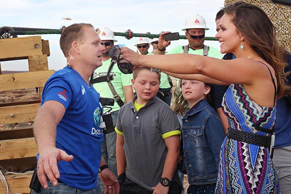 Aerialist Nik Wallenda, left, is welcomed by his wife, Erendira, after walking a 2-inch-thick steel cable that took him a quarter mile over the Little Colorado River Gorge in northeastern Arizona.
