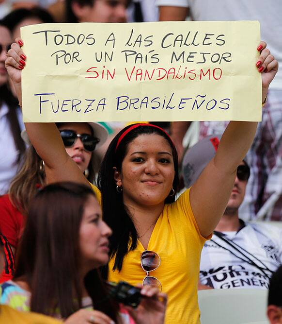 A spectator holds a sign
