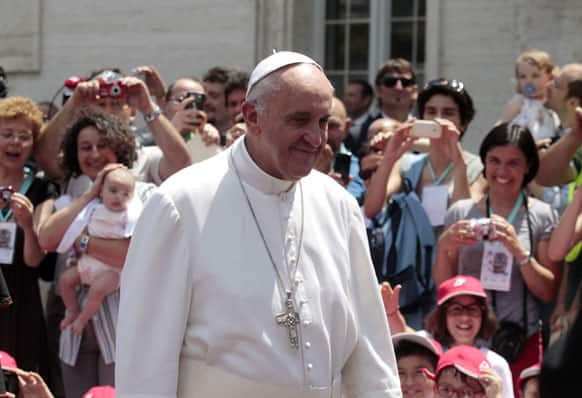 Pope Francis arrives to welcome a group of children who traveled on a special train from Milan and arrived at the St. Peter station at the Vatican.
