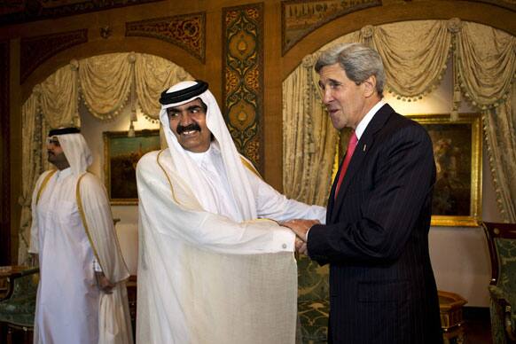 US Secretary of State John Kerry, right, is greeted by Qatari Emir Hamad bin Khalifa Al Thani at Wajbah Palace in Doha, Qatar.