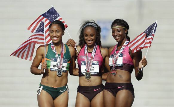 Brianna Rollins, celebrates winning the senior women`s 100-meters hurdles final with second-placed Queen Harrison and third-placed Nia Ali, on the victory stand at the US Championships athletics meet, in Des Moines, Iowa.