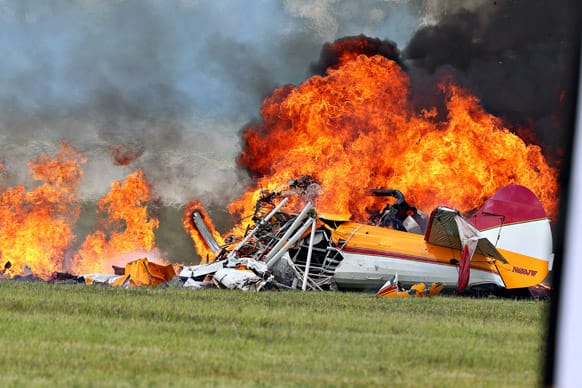 Flames erupt from a plane after a stunt plane crashed while performing with a wing walker at the Vectren Air Show.
