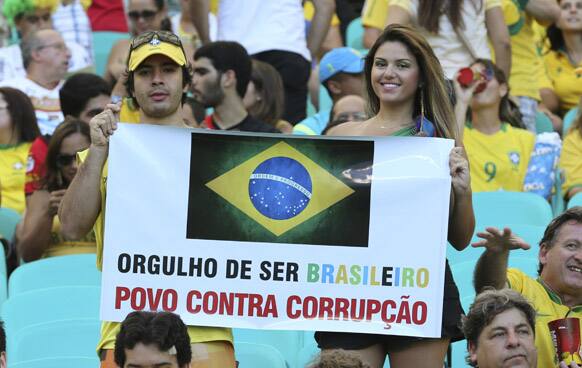 Spectators hold a sign