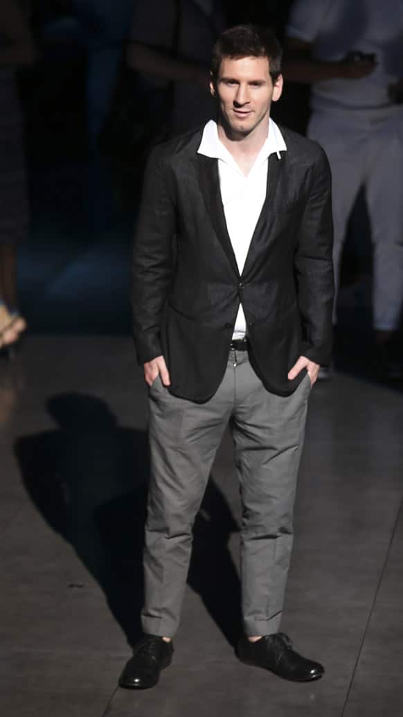 Argentine soccer star Lionel Messi poses in front of photographers prior to the start of the Dolce & Gabbana men`s Spring-Summer 2014-15 collection show, part of the Milan Fashion Week, unveiled in Milan, Italy.