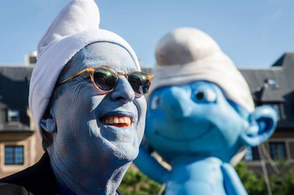 US film producer of the Smurfs 2 movie Jordan Kerner smiles as he stands in front of a giant inflatable Smurf during the Global Smurfs Day gathering in Brussels.